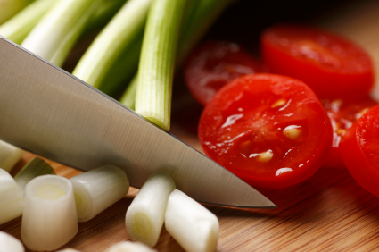 Knife cutting tomatoes